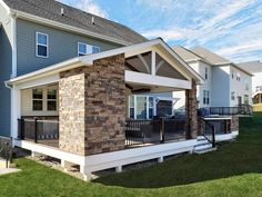 a house with a covered porch in front of it and grass on the ground next to it