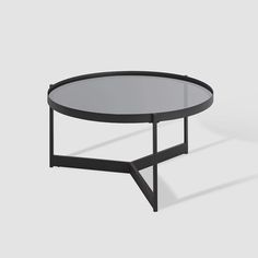 a black table with a glass top and metal frame on the bottom, against a white background