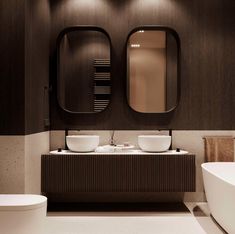 a bathroom with two sinks and mirrors above the sink, next to a bathtub