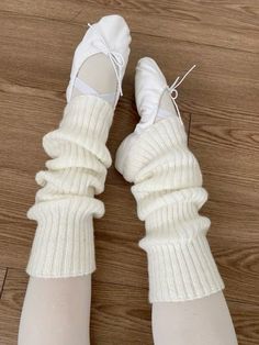 the legs and ankles of a woman wearing white socks with laces on them are shown from above