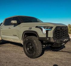 a gray truck is parked in the desert