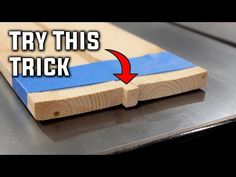 a piece of wood with the words try this trick in red and blue on it