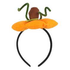 a headband with an orange flower and a green frog on it's back