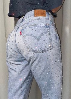 Vintage Levi 501 denim jeans - remade by us with high quality AB crystal rhinestones These jeans are very rare because there's only 10% of Levi jeans that has a red tab without letters! The model is normally a size EU34 | US25/26, so this would be a size EU36/38 US27/28. Please check the measurements. Waist: 75 cm Hip: 94 cm Length: 100cm Jeans condition: 9/10 Please note that due to the handmade nature of our creations, some items may have minor imperfections. Vintage items may have signs of wear. Any noticeable flaws will be clearly communicated in the item description. *We don't accept returns or cancellations, please make sure you carefully read the description before purchasing. Sparkle Jeans Outfit, Bedazzled Jeans Outfits, Sparkly Jeans Outfit, Glitter Jeans Outfit, Bedazzle Jeans, Rhinestone Jeans Aesthetic, Party Jeans With Blue Rhinestones, Diy Rhinestone Jeans, Y2k Bedazzled Jeans