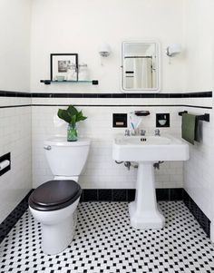 the bathroom is decorated in black and white