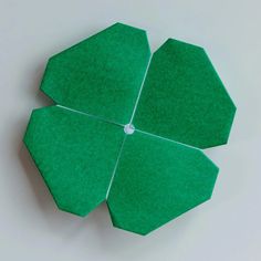 an origami flower made out of green felt