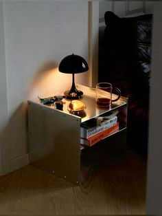 a table with a lamp and some books on it