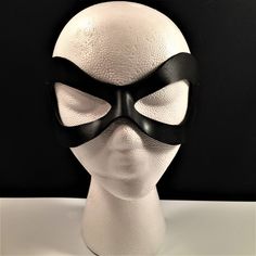 DESCRIPTIONAdd spice to your love life! This small, very lightweight, black leather mask is perfect for the beginner dominatrix or Lord of the Bedroom. Any color. Silver studs available. Waterproofed leather, glossy or matte finish, & several choices to affix the mask (cord, elastic, ribbon, waterproof cord, stick, or no holes for adhesive). Measurements: 3" high x 7" wide (tallest & widest points); 1" high between the eyes; 2.75" wide x 2.75" tall eye openings ---------------------------------- Lone Ranger Costume, Splatoon Costume, Robin Superhero, Comicon Costume, Ranger Costume, New Years Eve Ball, Masquerade Prom, Robin Cosplay, Superhero Masks