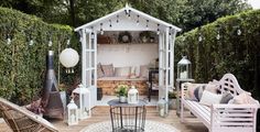 an outdoor living area with furniture and decor