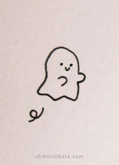 a drawing of a ghost with eyes and nose drawn on the side of a wall