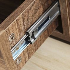 a close up view of a drawer with metal latches on the bottom and sides