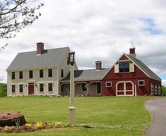 a large red house sitting on top of a lush green field