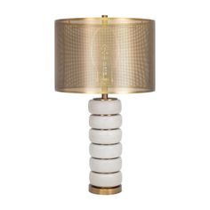 a table lamp with a white and gold shade on the top, sitting against a white background