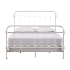 a white metal bed frame with two pillows