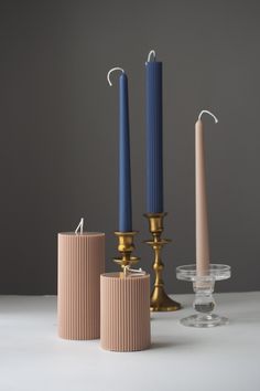 three candles sitting next to each other on a table