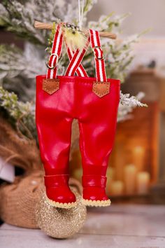 a pair of red boots hanging from a christmas tree