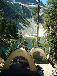 two tents set up on the side of a mountain