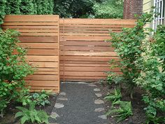 a wooden gate in the middle of a garden