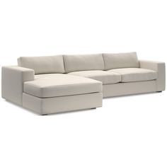 a white sectional couch sitting on top of a white floor