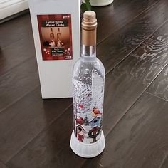 an empty bottle sitting on top of a wooden floor