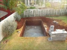 an unfinished pool in the middle of a yard