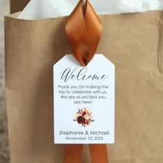 a brown paper bag with a welcome tag attached to it