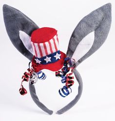 a stuffed rabbit wearing a red, white and blue hat with stars on it's ears