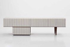 the bench is made out of wood and has striped upholstered fabric on it