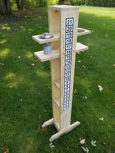 a wooden stand with numbers on it in the grass