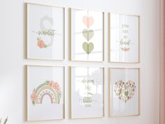 four framed art prints hanging on the wall in a room with pink and green accents