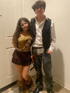 two people dressed up in costumes standing next to each other