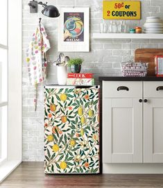 a kitchen with white brick walls and colorful tile on the cabinet doors, along with an old fashioned refrigerator