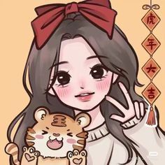 the girl is holding a small tiger in her hand and wearing a red bow on her head