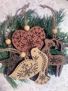 three wooden ornaments hanging from a christmas tree