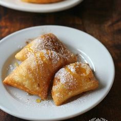 two plates with pastries on them sitting on a table