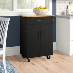 a kitchen cart with a bowl of fruit on top