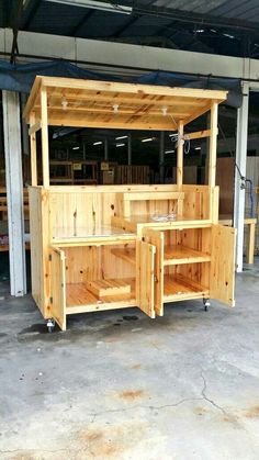 an outdoor bar made out of pallets in a garage with no one around it