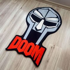 a door mat with an image of the head of a robot in red and black