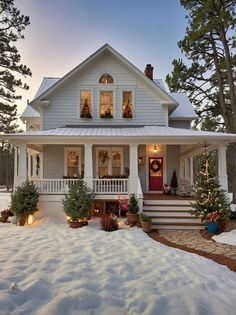 a white house with christmas decorations on the front porch