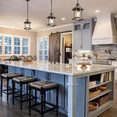 a large kitchen with an island in the middle and lots of stools around it