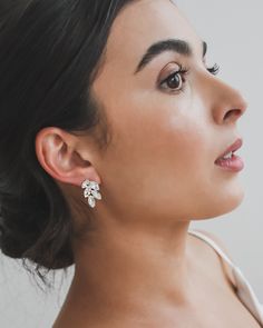 a close up of a person wearing earrings