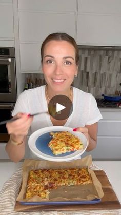 a woman holding a plate with food on it