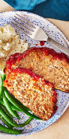 meatloaf, green beans and mashed potatoes on a plate with a fork