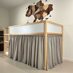 a bunk bed with curtains and a map on the wall