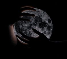 a person holding the moon in their hands