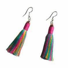 two pairs of earrings with tassels hanging from them