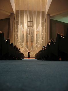 the interior of a church with sheer curtains