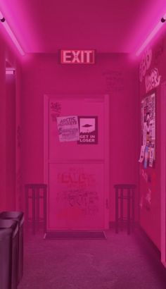 a pink hallway with graffiti on the walls and exit sign above it that says exit