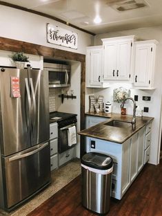 a kitchen with stainless steel appliances and white cabinets