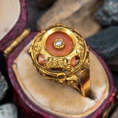 This vintage coral ring features a dome that encases a coral gem that is centered with a rose cut diamond. The coral has some movement inside the dome by design. The ring is crafted of 10k yellow gold and shows a lovely unpolished patina. Heirloom Style Domed Ring For Formal Occasions, Heirloom Dome Ring With Rose Cut Diamonds, Heirloom Oval Dome Ring With Rose Cut Diamonds, Vintage Domed Dome Ring As Gift, Vintage Domed Ring For Gift, Vintage Domed Ring As A Gift, Vintage Dome Ring As A Gift, Gemstone Dome Ring For Wedding, Anniversary Gemstone Dome Ring